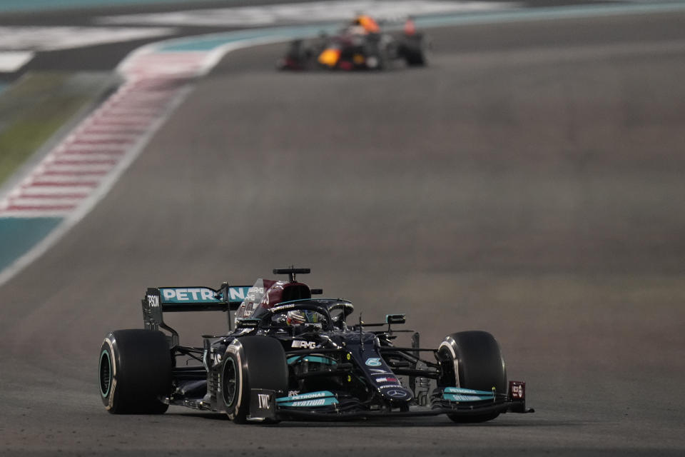 Mercedes driver Lewis Hamilton of Britain in action in front of Red Bull driver Max Verstappen of the Netherlands during the Formula One Abu Dhabi Grand Prix in Abu Dhabi, United Arab Emirates, Sunday, Dec. 12. 2021. (AP Photo/Hassan Ammar)