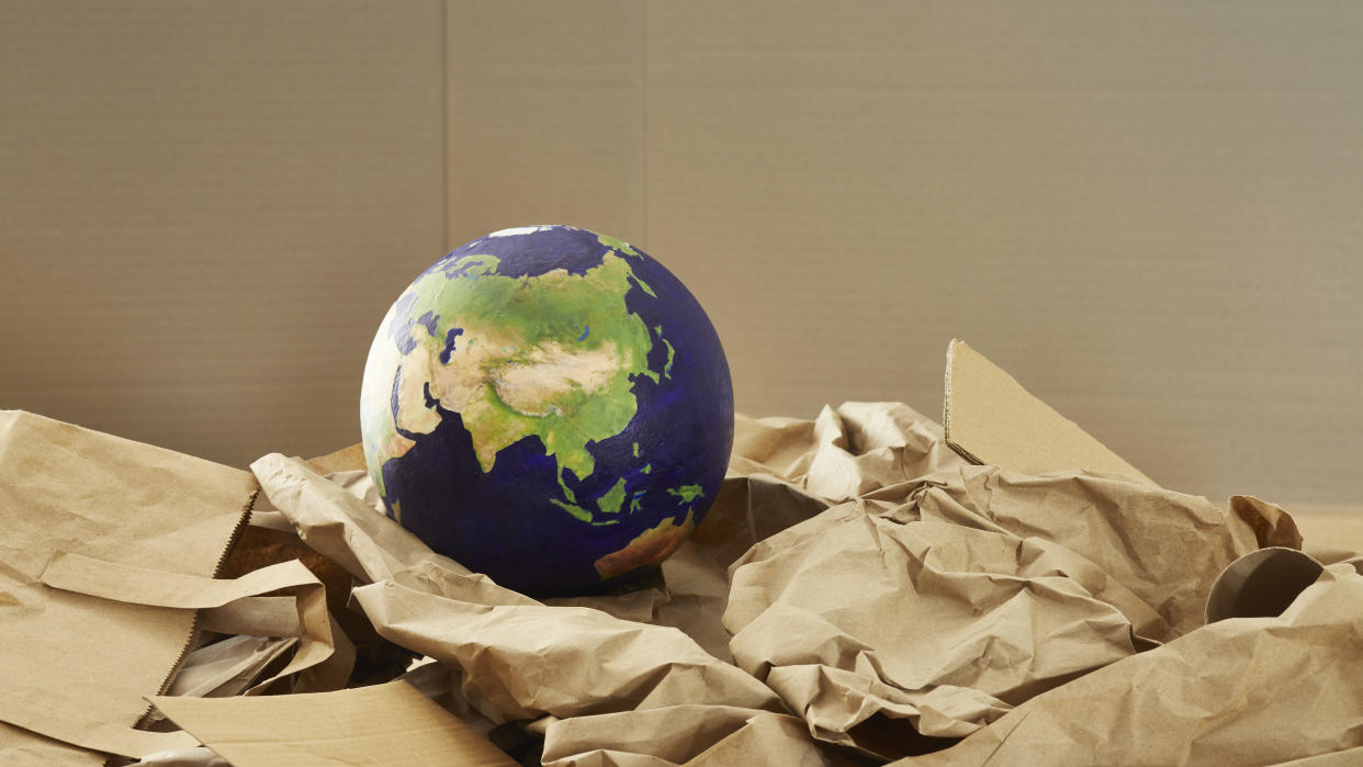  A globe of the Earth in recycled packaging. . 