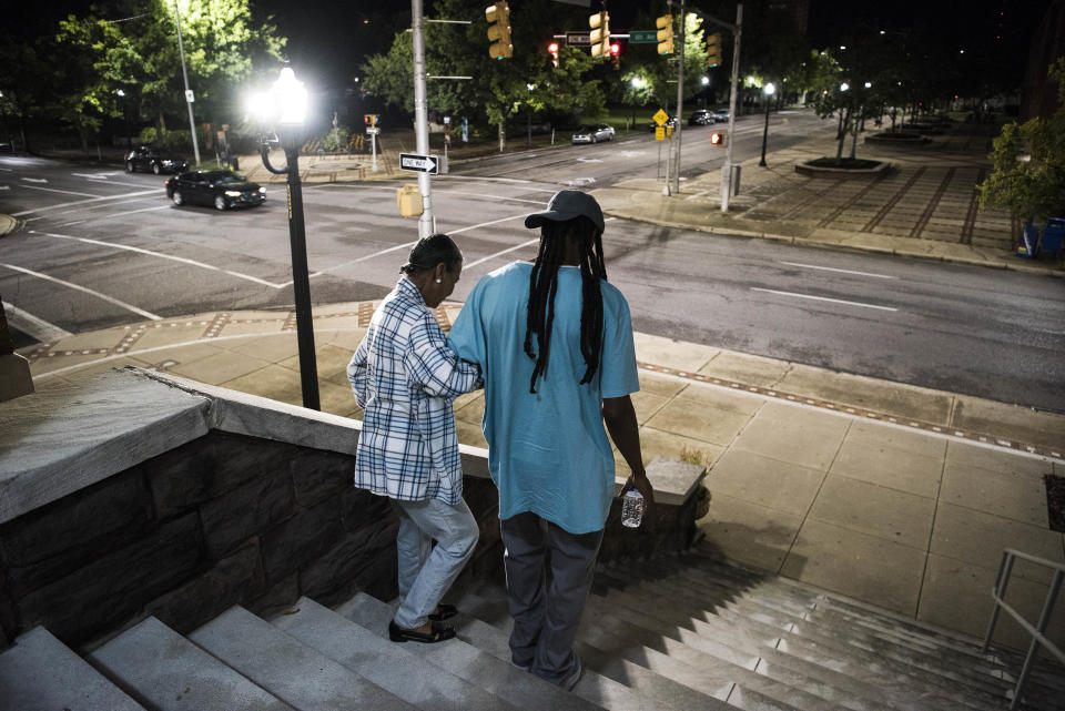 Eric Craig helps a person down the stairs after&nbsp;the "Overcoming and Surviving Inner City Violence in Birmingham" event.