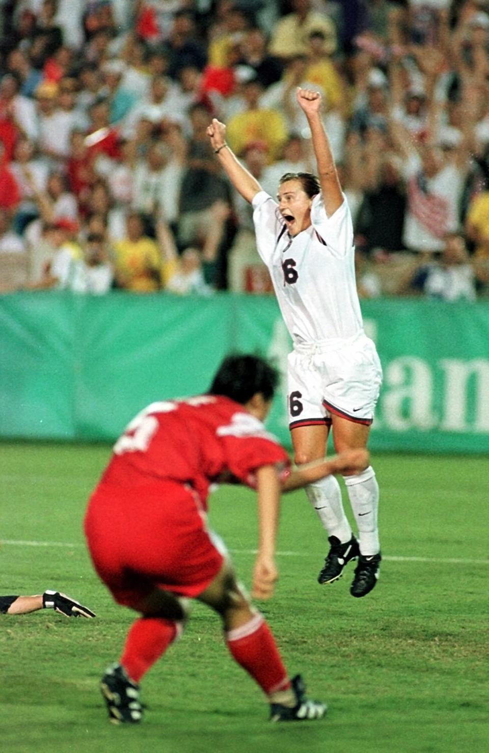 FILE - In this Thursday, Aug. 1, 1996, file photo, Tiffeny Milbrett of the U.S. Olympic soccer team reacts after scoring the goal that won the gold medal for the U.S. against China at Sanford Stadium in Athens, Ga. The U.S. beat China 2-1.(AP Photo/Joe Cavaretta, File)