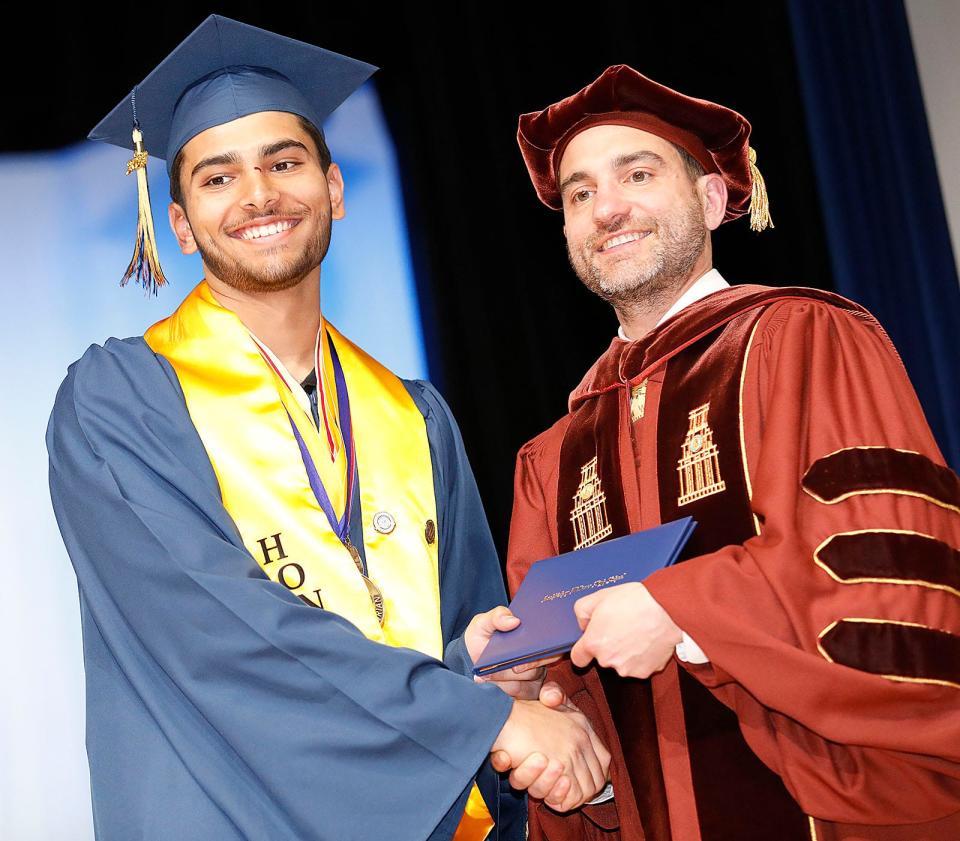 Valedictorian Zen Abidi receives his diploma from Principal Michael Volonnino at the Archbishop Williams High School graduation in Braintree on Thursday, May 25, 2023.