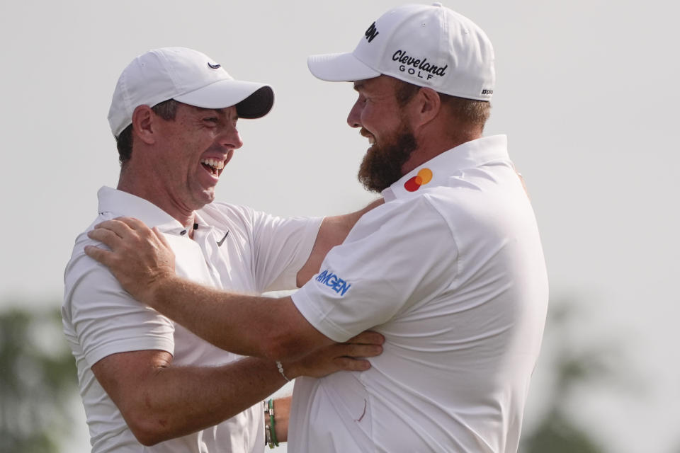 Shane Lowry, of Ireland, right, embraces his teammate Rory McIlroy, of Northern Ireland, after winning the PGA Zurich Classic golf tournament at TPC Louisiana in Avondale, La., Sunday, April 28, 2024. (AP Photo/Gerald Herbert)