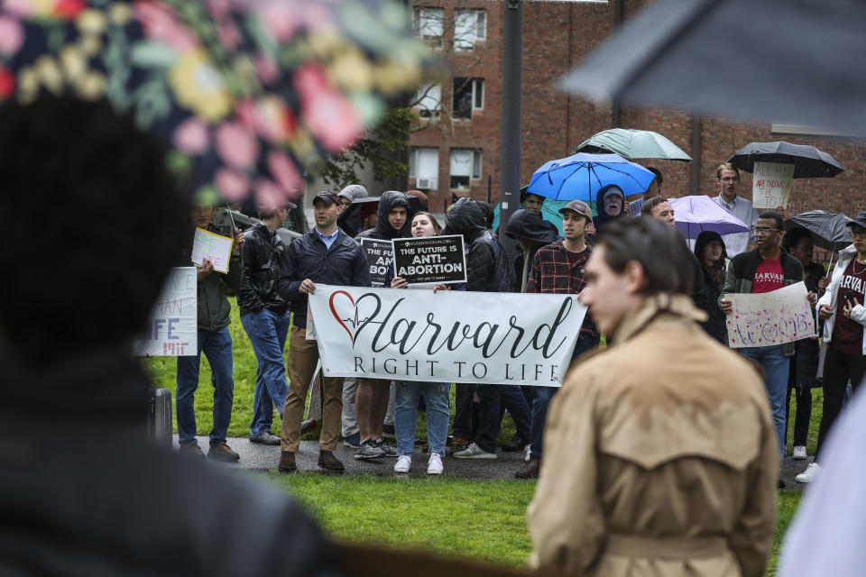 Counterprotesters at Harvard hold a sign that reads Harvard Right To Life as they are met by students who rallied on May 4, 2022.