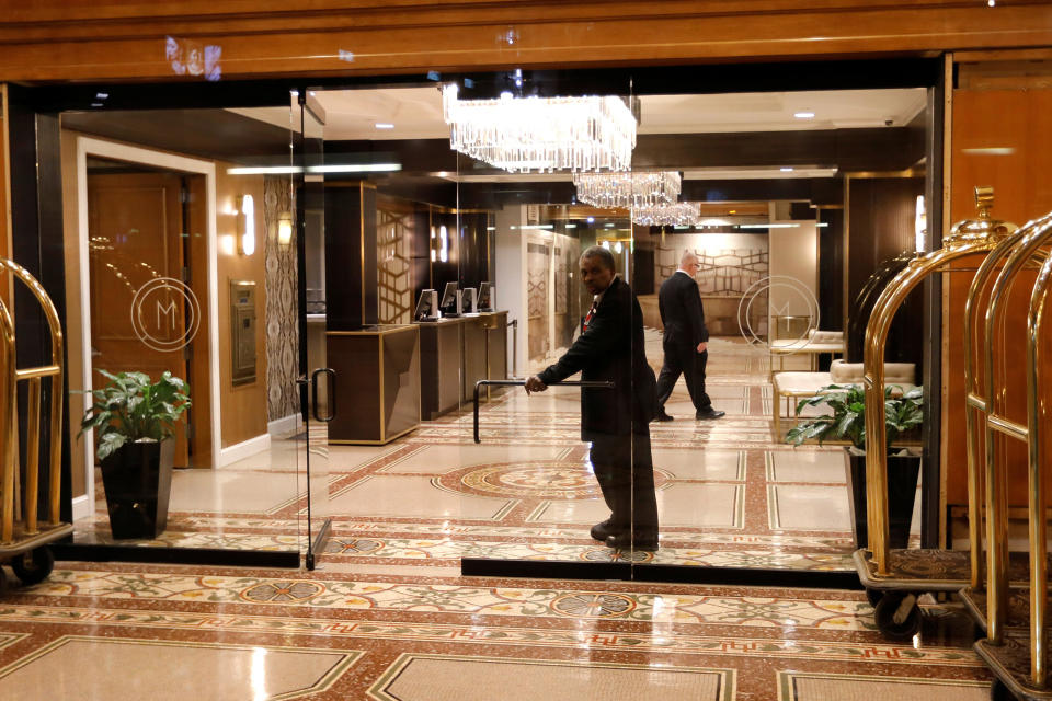 A doorman looks out from an empty hotel lobby in Herald Square in Manhattan during the coronavirus outbreak in New York City on March 18, 2020. (Mike Segar / Reuters)