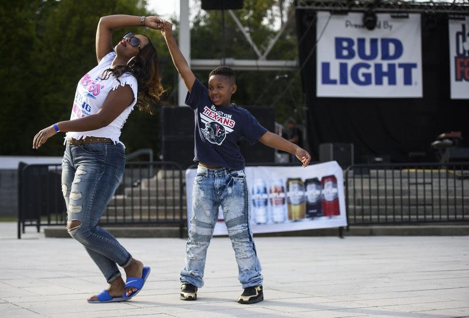 Kristen Braswell is twirled by her son Justin Braswell as they dance to live music at the Dogwood Fall Festival in October 2017.