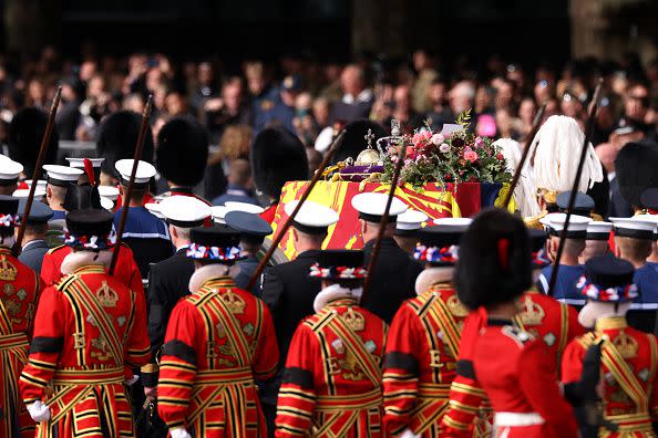 LONDON, ENGLAND - SEPTEMBER 19: The Queen's funeral cortege borne on the State Gun Carriage of the Royal Navy and Yeoman of the Guard travels along The Mall on September 19, 2022 in London, England. Elizabeth Alexandra Mary Windsor was born in Bruton Street, Mayfair, London on 21 April 1926. She married Prince Philip in 1947 and ascended the throne of the United Kingdom and Commonwealth on 6 February 1952 after the death of her Father, King George VI. Queen Elizabeth II died at Balmoral Castle in Scotland on September 8, 2022, and is succeeded by her eldest son, King Charles III.  (Photo by Dan Kitwood/Getty Images)