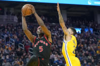 Toronto Raptors forward Precious Achiuwa (5) shoots against Golden State Warriors guard Chris Chiozza (2) during the first half of an NBA basketball game in San Francisco, Sunday, Nov. 21, 2021. (AP Photo/Jeff Chiu)