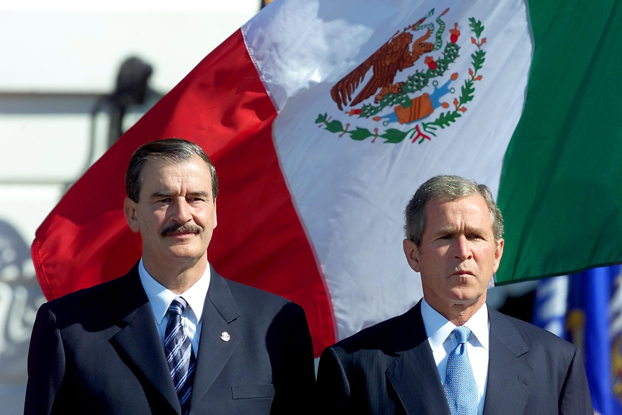 WASHINGTON, UNITED STATES:  Mexican President Vicente Fox (L) and US President George W. Bush listen to national anthems during the State arrival ceremony for the Mexican president 05 September, 2001 in Washington, DC.    AFP PHOTO / TIM SLOAN (Photo credit should read TIM SLOAN/AFP via Getty Images) (Tim Sloan / AFP via Getty Images file)