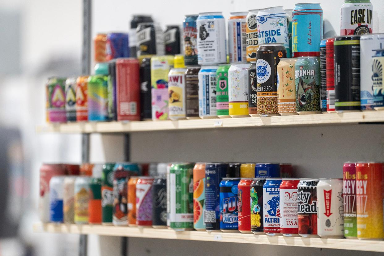 Example cans line shelves in the warehouse at Canworks Wednesday, Jan. 16, 2024. The facility prints thousands of cans a day, helping businesses across the country.