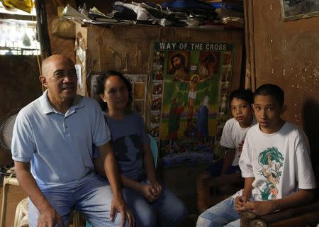 Roman Catholic priest Father Jess Siva poses with his common law wife Bemma and children at their home in Iloilo city on Panay island in central Philippines January 10, 2015. REUTERS/Erik De Castro