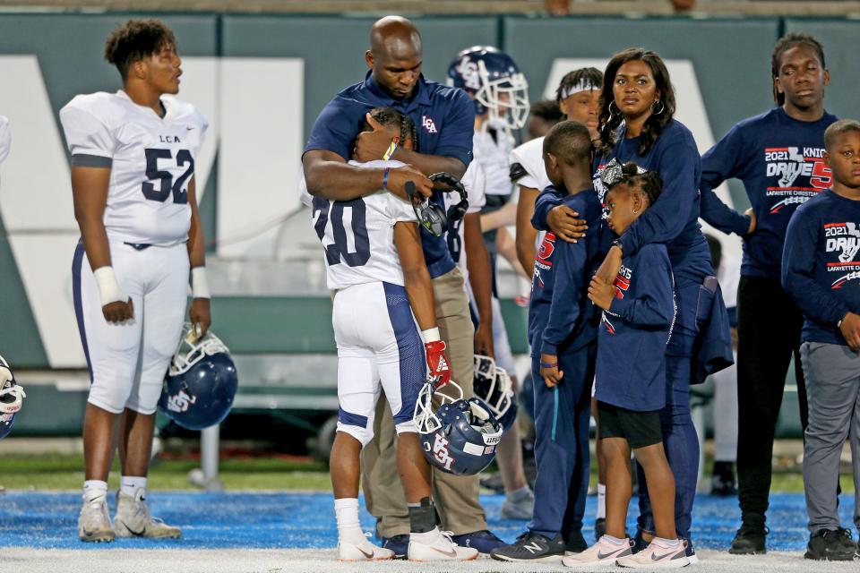 LCA head coach Trev Faulk embraces Dedrick Celestine (20) after the Division III State Championship game between Lafayette Christian Academy and St. Charles Catholic at Tulane’s Yulman Stadium on Saturday, December 4, 2021.