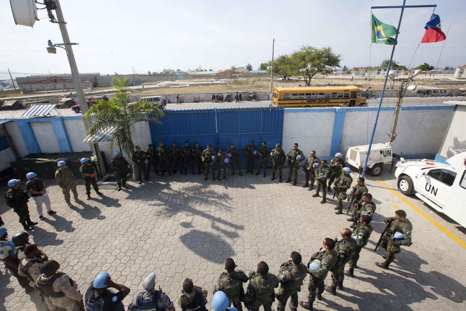 In this Feb. 22, 2017 photo, U.N. peacekeepers from Brazil meet before patrolling in the Cite Soleil slum, in Port-au-Prince, Haiti. The U.N.'s first-ever "stabilization" mission came to Haiti in 2004 following a rebellion that had the country on the brink of collapse and ousted then-President Jean-Bertrand Aristide. (AP Photo/Dieu Nalio Chery)