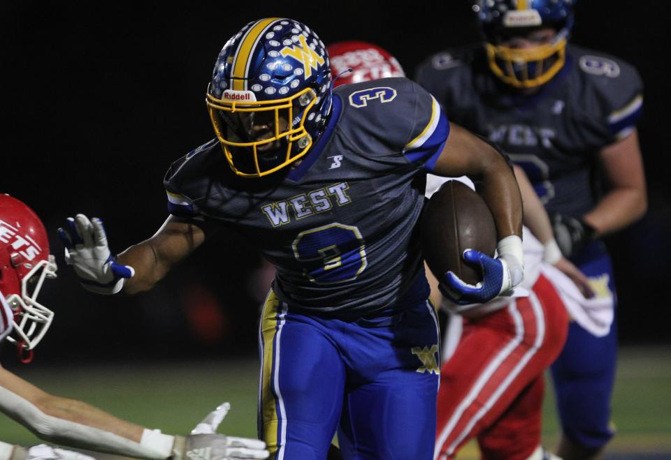 West Muskingum's Rashid SeSay carries the ball against Union Local.