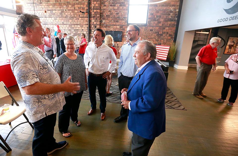 Good Deed Entertainment owner Scott Donley, Republican Central Committee Chair Jane Roland, Ashland County Republican Party Chairman and city Mayor Matt Miller, Common Pleas Judge-elect Dave Stimpert and former county Republican Party Chairman Robert Desanto chat at an event celebrating the Republican Party's new home in Donley's building on East Main Street downtown.