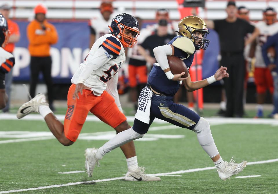 Newburgh' quarterback Mason Hoover (10) looks for some running room in the Bennett defense during the state Class AA football championship at JMA Wireless Dome in Syracuse Dec. 4, 2022. 