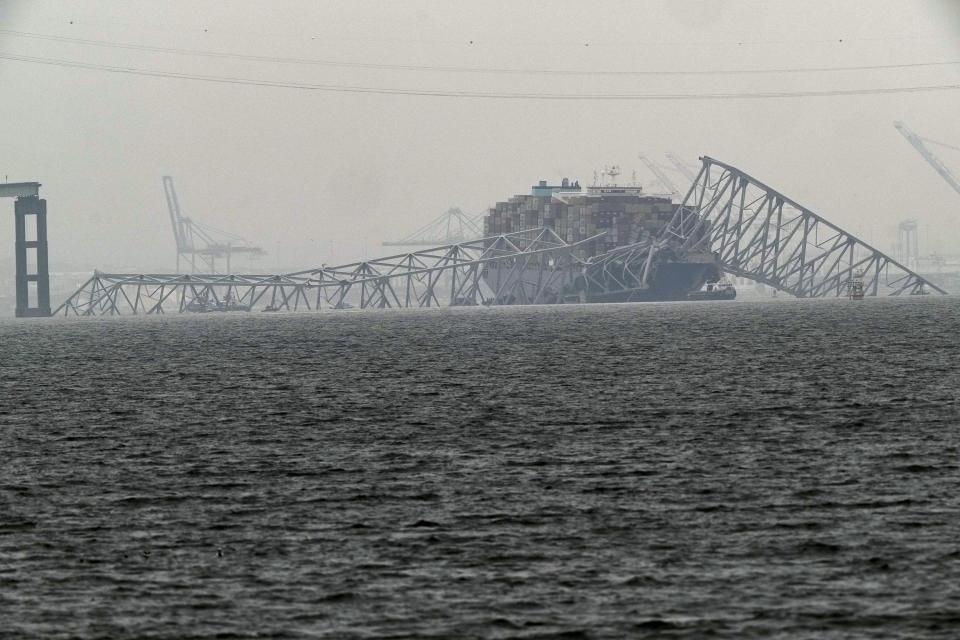 A container ship rests against the wreckage of the Francis Scott Key Bridge on Thursday, March 28, 2024, in Baltimore, Md. After days of searching through murky water for the workers missing after the bridge collapsed, officials are turning their attention Thursday to what promises to be a massive salvage operation. (AP Photo/Matt Rourke)