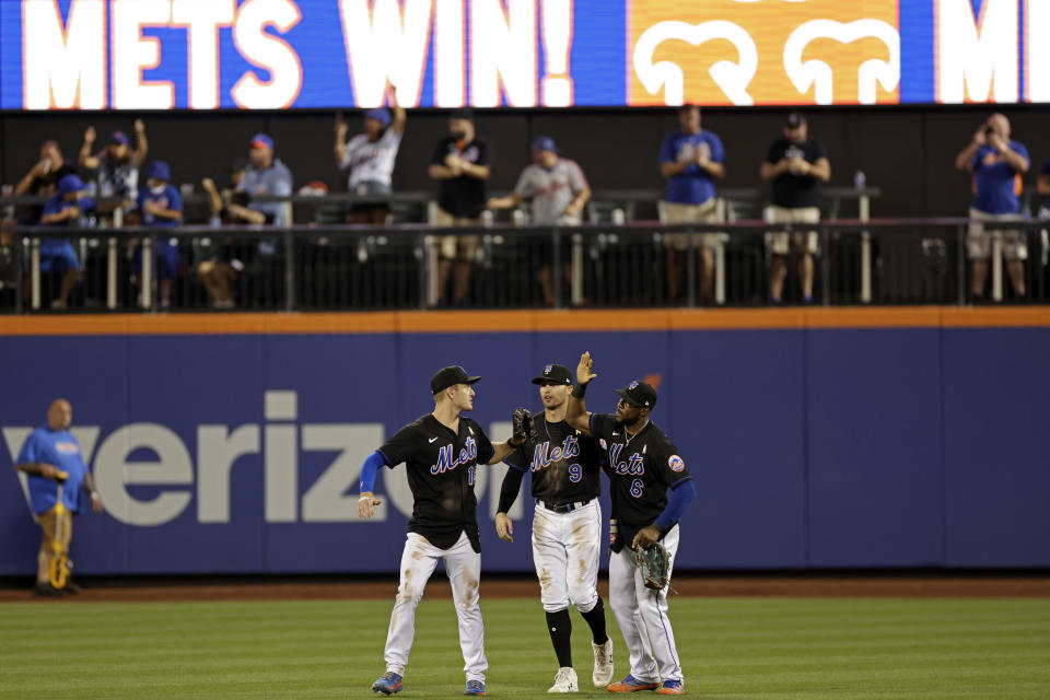 New York Mets left fielder Mark Canha celebrates with Brandon Nimmo (9) and Starling Marte (6) after the Mets defeated the Washington Nationals 7-3 n a baseball game Friday, Sept. 2, 2022, in New York. (AP Photo/Adam Hunger)