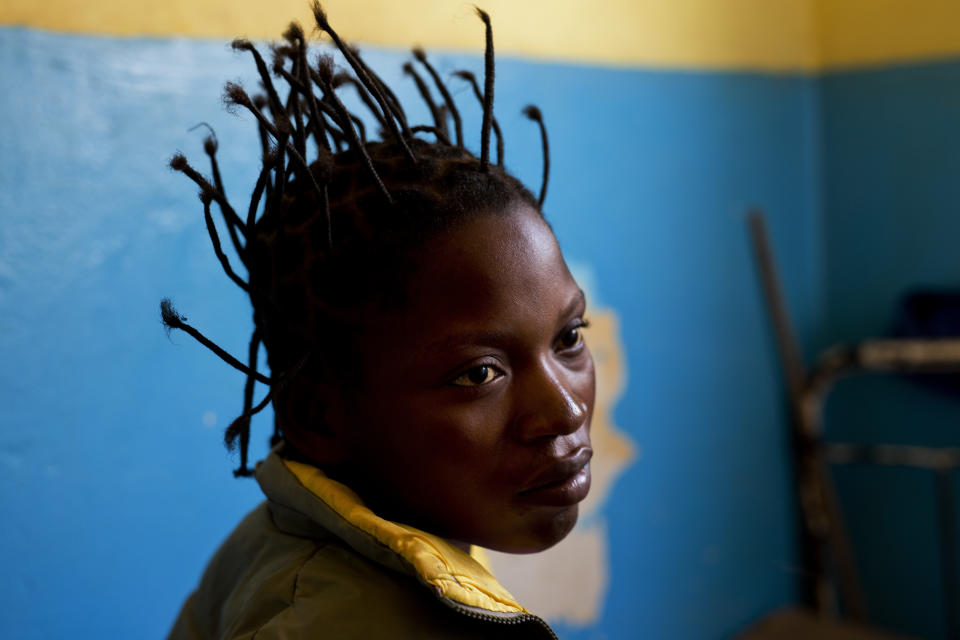 Kimenua Ngoie, 22, sits on her hospital bed at the Katuba Reference Hospital in Lubumbashi, Democratic Republic of the Congo on Monday, Aug. 13, 2018. Ngoie, who lost her baby at birth following a C-section, has been effectively imprisoned by the hospital for the past there month, unable to pay the $360 costs of her operation. An Associated Press investigation found that of more than 20 hospitals and clinics visited in Lubumbashi, all but one detain patients, an illegal practice according to the Congolese penal code. (AP Photo/Jerome Delay)