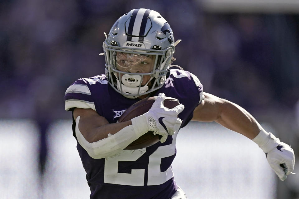 FILE - Kansas State running back Deuce Vaughn runs the ball during the first half of an NCAA college football game against TCU, Saturday, Oct. 30, 2021, in Manhattan, Kan. The Big 12 will begin its 27th season this week with some uncertainty of what will stand out offensively since there are three new head coaches and plenty of different skill players. (AP Photo/Charlie Riedel, File)