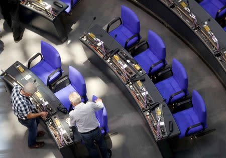 Technicians prepare the seats at the plenary hall of the German lower house of parliament (Bundestag) at the Reichstag building in Berlin, Germany, October 18, 2017. REUTERS/Hannibal Hanschke