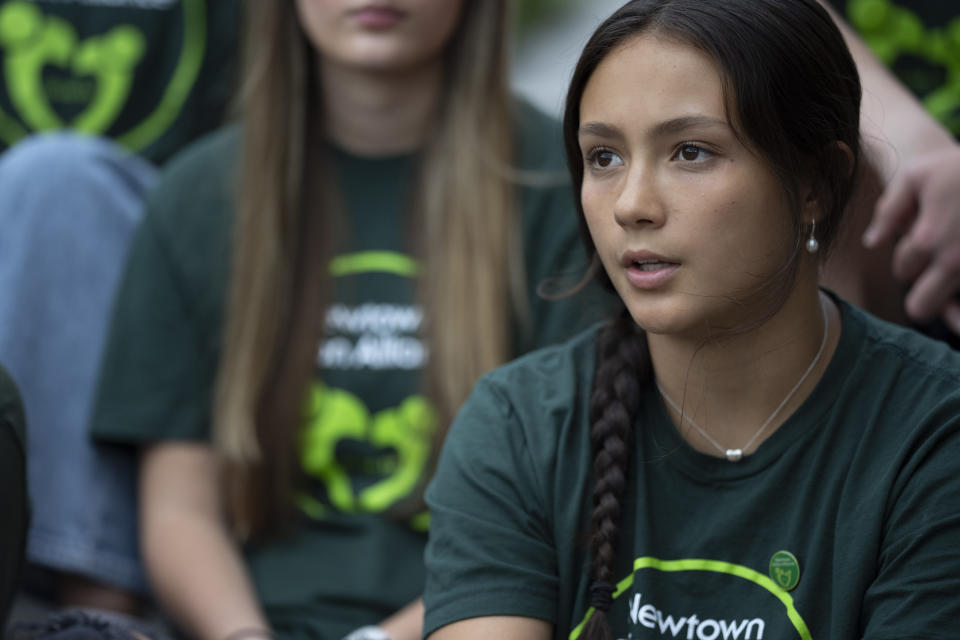 Grace Fischer, a survivor of the 2012 Sandy Hook Elementary School shooting, talks about upcoming high school graduation, before a rally against gun violence on Friday, June 7, 2024, in Newtown, Conn. (AP Photo/Bryan Woolston)