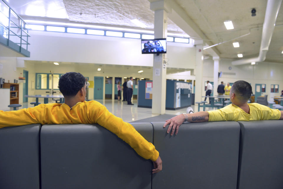 In this July 9, 2019 photo, clients watch TV at the Stonybrook Stabilization and Treatment Center at the Hampden County Correctional Center in Ludlow, Mass. Sheriff Thomas Cocchi and his supporters have said the program, one of just three in the state treating civilly committed men and the only in western Massachusetts, can play a key role in efforts to curb the Springfield area's opioid problem. But civil rights group want the practice of imprisoning men for addiction treatment ended. (Don Treeger/The Republican via AP, File)