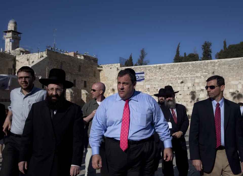 New Jersey Gov. Chris Christie, center, walks at the Western Wall, the holiest site where Jews can pray, during his visit to Jerusalem's old city, Monday, April 2, 2012. Christie kicked off his first official overseas trip Monday meeting Israel's leader in a visit that may boost the rising Republican star's foreign policy credentials ahead of November's presidential election. (AP Photo/Sebastian Scheiner)