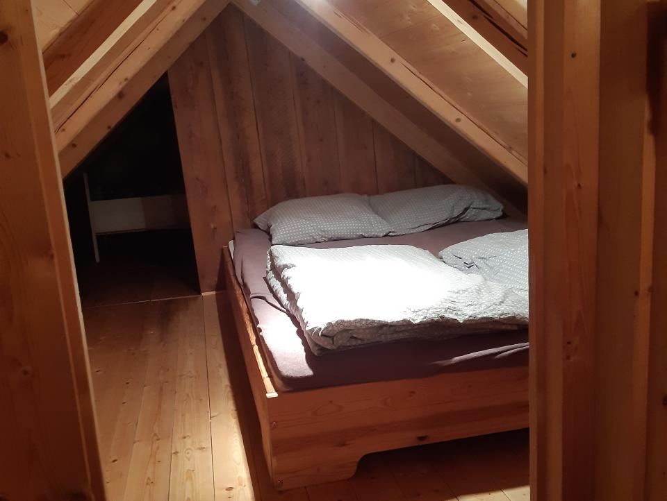 Small wood-covered room with a bed inside