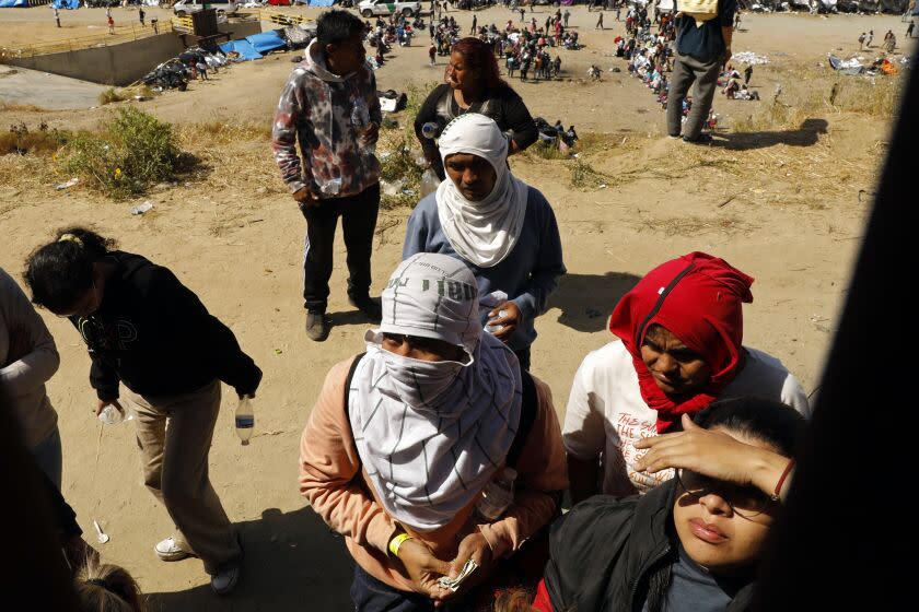 Tijuana, Mexico-May 10, 2023-Migrants hoping to cross into the United States from Tijuana, Mexico, wait in an area south of the second border wall in anticipation of a change in immigration policy, Title 42, which may allow them to apply for asylum. The change is scheduled to go into effect at midnight on May 11, 2023. (Carolyn Cole / Los Angeles Times)