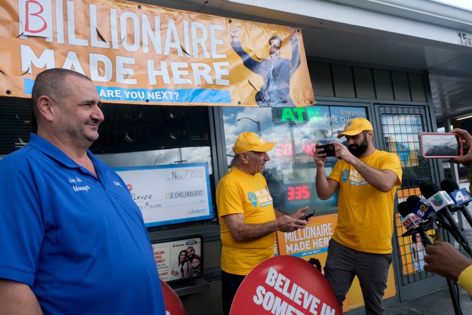 Joseph Chahayed poses for a photo after receiving $1 million from lottery officials.