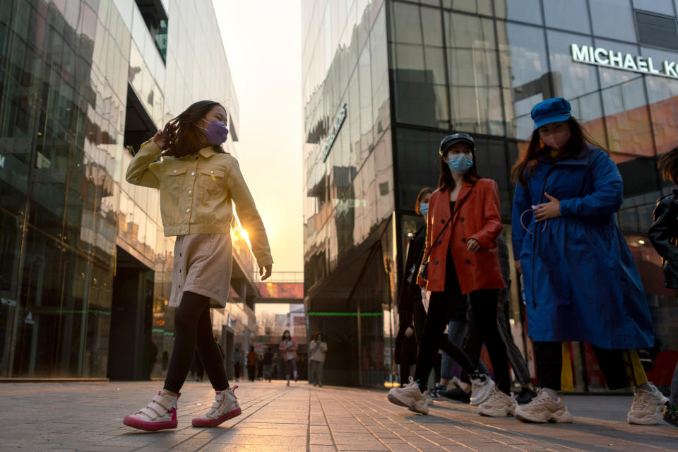 BEIJING, CHINA - MARCH 30, 2020: People wear protective face masks in a shopping and entertainment area in the Chinese capital. Since the start of the coronavirus outbreak in China, 93% of COVID-19 infected patients have recovered. The authorities imposed a two-week quarantine and took a number of measures to prevent a second wave of pneumonia. Artyom Ivanov/TASS (Photo by Artyom Ivanov\TASS via Getty Images)