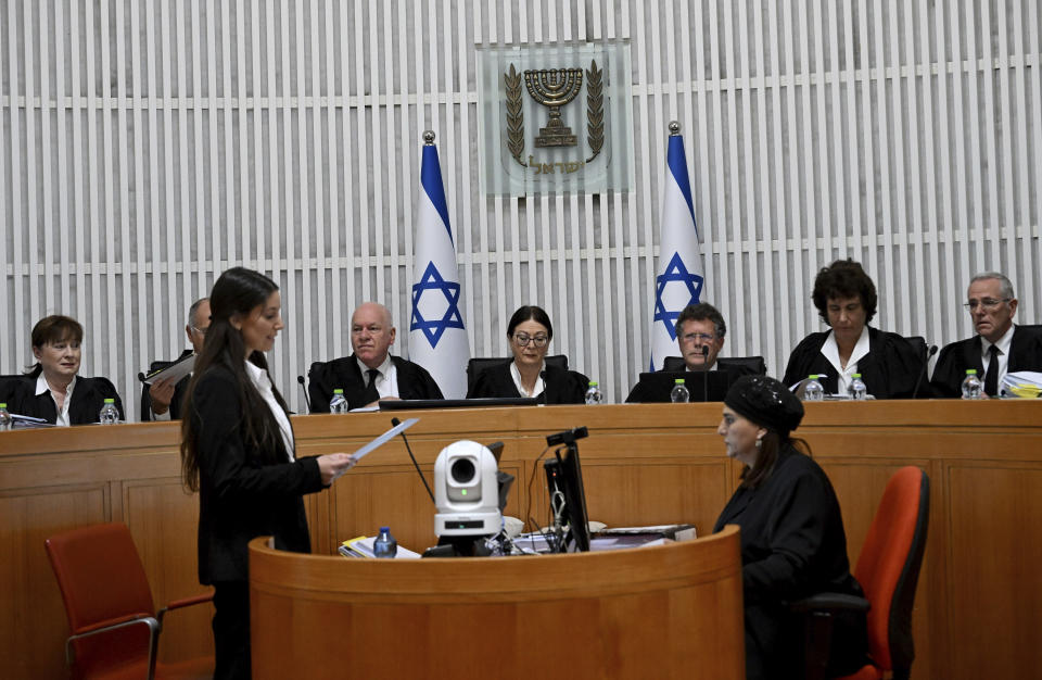 Esther Hayut, chief justice of the Supreme Court of Israel, center, sits on the bench with Israel's Supreme Court justices to look at the legality of Prime Minister Benjamin Netanyahu's contentious judicial overhaul, which the government pushed through parliament in July, in Jerusalem, Tuesday, Sept. 12, 2023. The divisive law, which cancels the court's ability to block government actions and appointments using the legal concept that they are "unreasonable," is the first piece of the wider government plan to weaken the Supreme Court. (Debbie Hill/Pool Photo via AP)