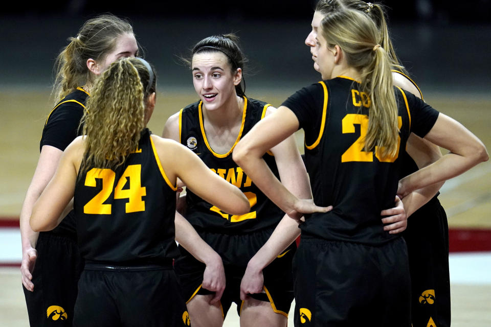 FILE - Iowa players, from left, Kate Martin, Gabbie Marshall, Caitlin Clark, Logan Cook and Monika Czinano huddle during the second half of an NCAA college basketball game against Maryland, Tuesday, Feb. 23, 2021, in College Park, Md. The average price of tickets for the Hawkeyes since Clark joined the team in 2020 is up 224% and the average distance traveled to watch Iowa play is up 34% compared to last season. (AP Photo/Julio Cortez, File)