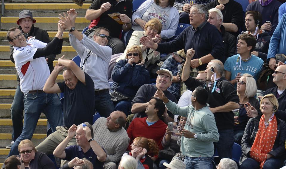 Spectators react as a ball lands in the stand hit for 6 runs by Australia's George Bailey during the fourth one-day international against England at Sophia gardens in Cardiff, Wales September 14, 2013. (REUTERS/Philip Brown)
