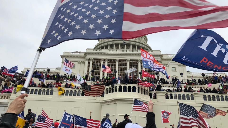 Rioters stand on the West front of the U.S. Capitol building to protest the official election of President-elect Joe Biden on Jan. 6, 2021.