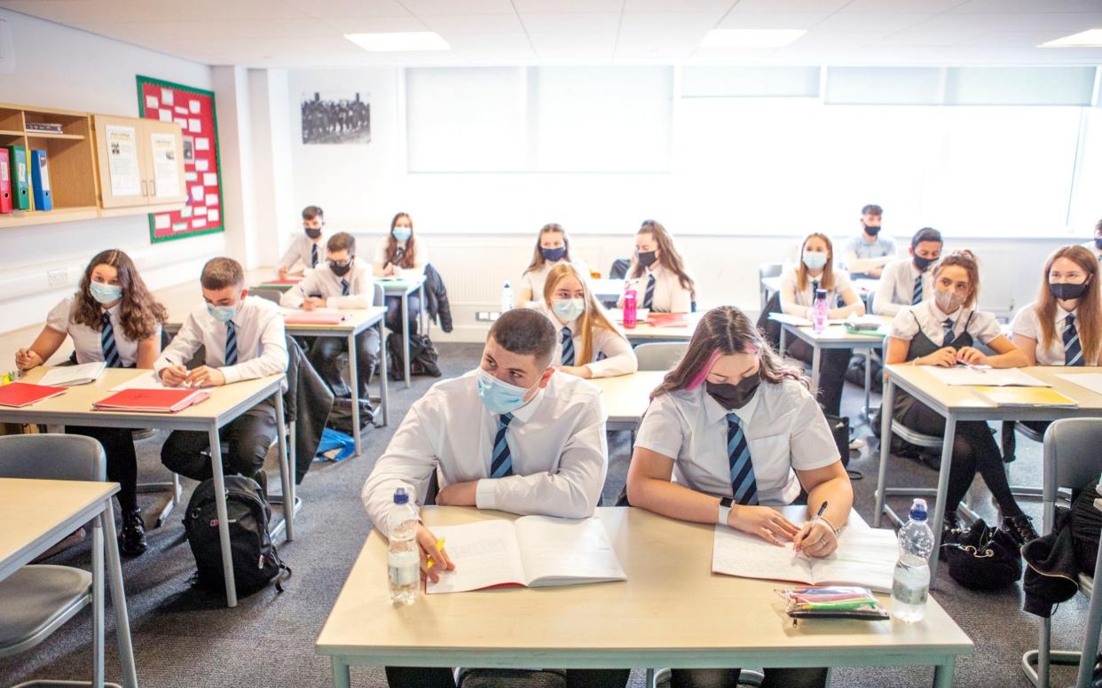 S5 and S6 pupils at St Columba's High School in Gourock, Inverclyde, wear protective face masks during their history lesson - PA