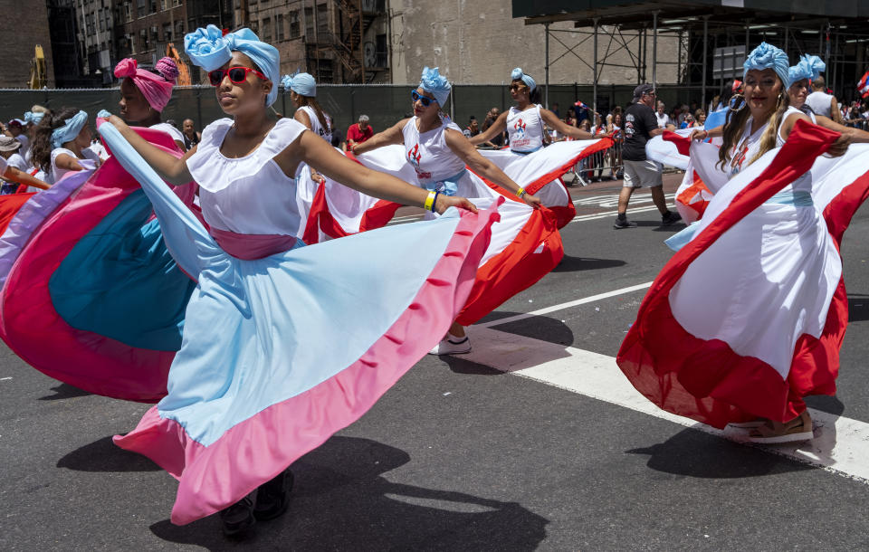 A parade unit entertains spectators during the National Puerto Rican Day Parade Sunday, June 9, 2019, in New York. (AP Photo/Craig Ruttle)