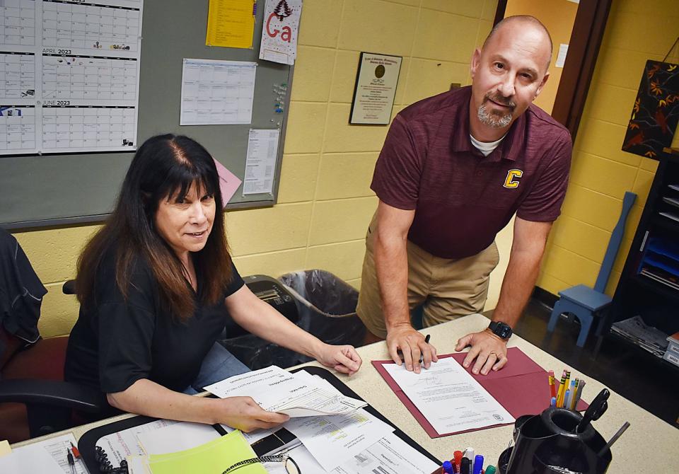 Pauline Simmons, administrative assistant, and Principal Christopher Costa in the Case High main office.