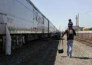 <p>Ringling Bros. boss clown Sandor Eke carries his 2-year-old son, Michael, on his shoulders as he walks to the bus that will take them to the arena for a show, Thursday, May 4, 2017, in Providence, R.I. Someday, he plans to teach his son juggling and other circus skills, but Eke knows he may never join the circus. Eke’s wife, a former circus aerialist, has already established their new home in Las Vegas. When the circus closes, Eke hopes to get a job as a “flair” bartender there, doing tricks like juggling bottles, but he wonders how life will change. “My normal life is this. My normal life is going on the train, going every week to a different city. It’s crazy how much I love circus,” Eke says. (Photo: Julie Jacobson/AP) </p>