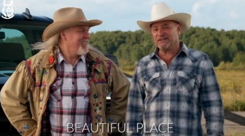 Two men in cowboy hats and plaid shirts stand smiling in front of a scenic outdoor background. Text on the image reads "BEAUTIFUL PLACE."