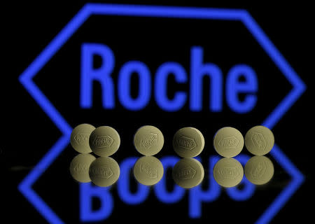 FILE PHOTO: Roche tablets are seen positioned in front of a displayed Roche logo in this picture illustration, January 22, 2016. REUTERS/Dado Ruvic/Illustration/File Photo