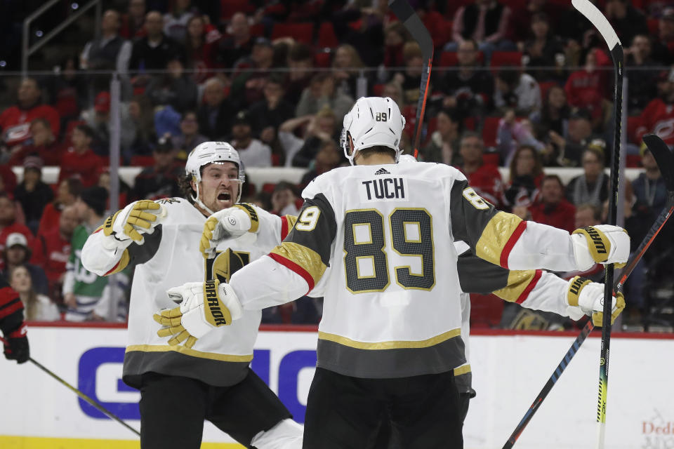 Vegas Golden Knights right wing Mark Stone reacts with right wing Alex Tuch (89) following Tuch's goal against the Carolina Hurricanes during the third period of an NHL hockey game in Raleigh, N.C., Friday, Jan. 31, 2020. (AP Photo/Gerry Broome)