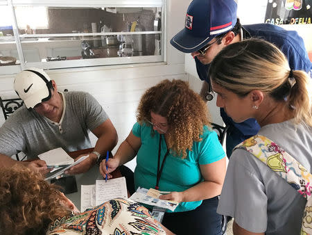 Doctors review prescriptions of patients in a elderly care facility in Orocovis, Puerto Rico on October 3, 2017. REUTERS/Robin Respaut