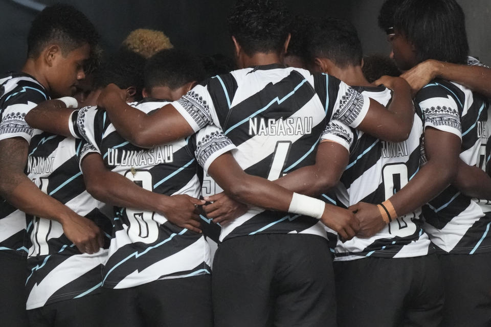 Fiji players huddle up as they prepare to enter the stadium for their women's rugby sevens quarterfinal match against Australia at the 2020 Summer Olympics, Friday, July 30, 2021 in Tokyo, Japan. (AP Photo/Shuji Kajiyama)