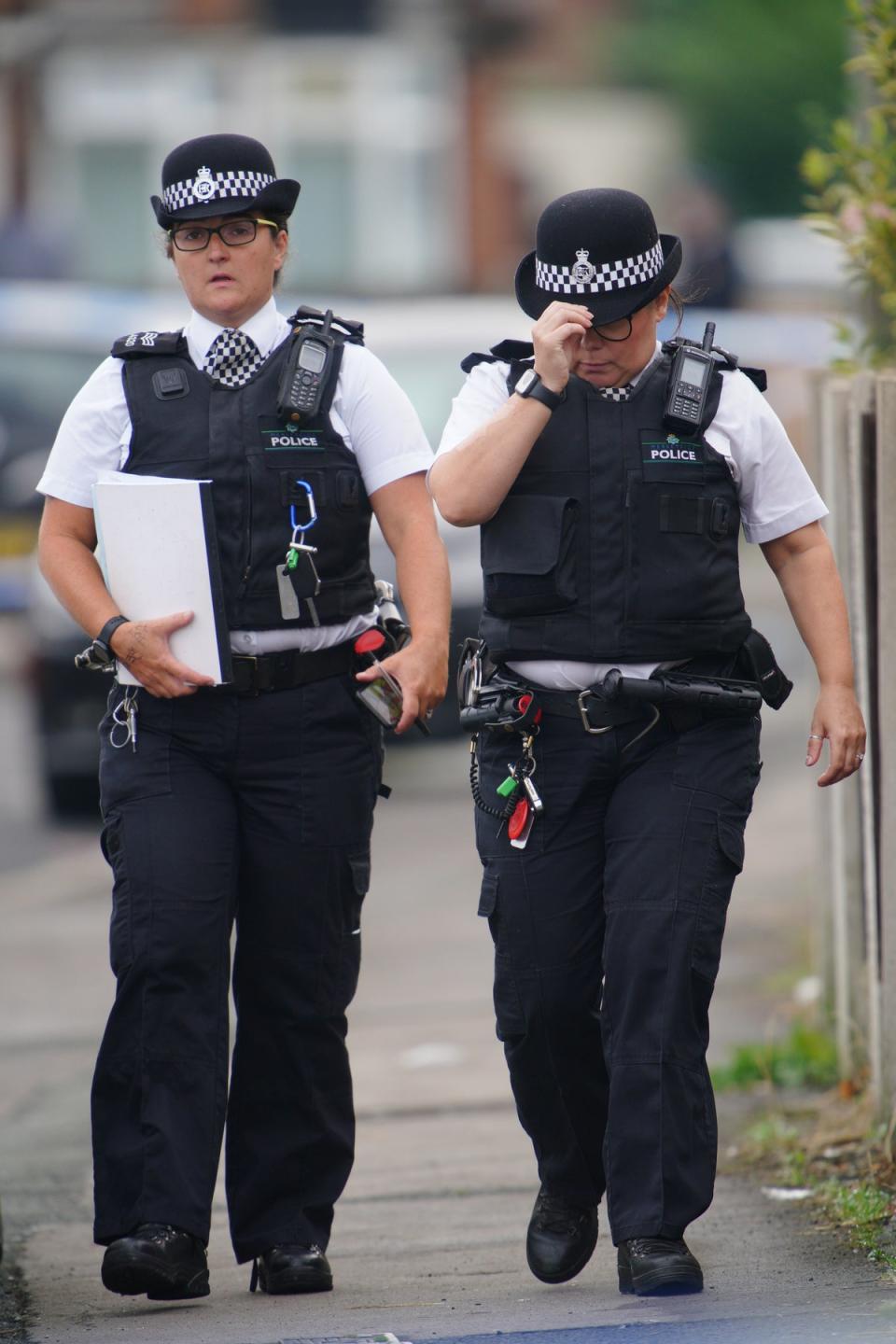 Police officers near to the scene in Kingsheath Avenue, Knotty Ash, Liverpool, where a nine-year-old girl was fatally shot (Peter Byrne/PA) (PA Wire)