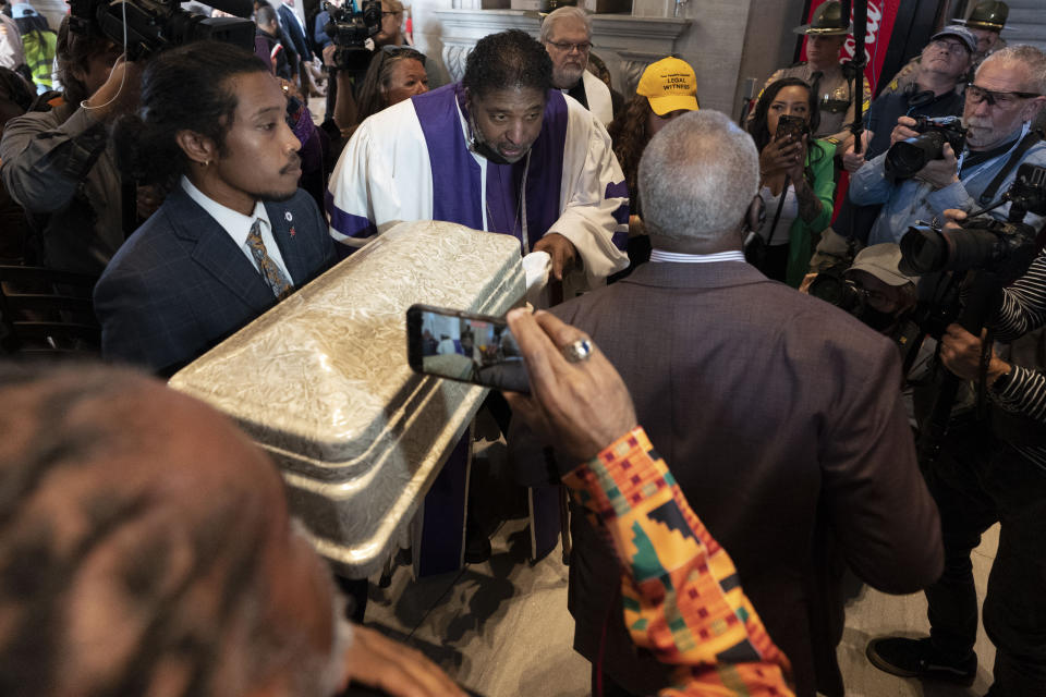Rep. Justin Jones, D-Nashville, left, and Rev. William J. Barber are blocked by a Sgt. at Arms as they try to bring a coffin into to the House chambers, Monday, April 17, 2023, in Nashville, Tenn. (AP Photo/George Walker IV)