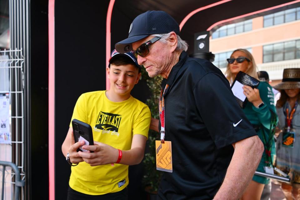 Michael Douglas greets a fan in the Paddock prior to the F1 Grand Prix of Monaco at Circuit de Monaco on May 28, 2023 (Getty Images)