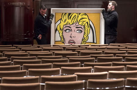 Workers wheel Roy Lichtenstein's "Nurse" through an emptied auction room following an auction where it sold for $95,365,000.00 at Christie's in Manhattan, New York November 9, 2015. REUTERS/Andrew Kelly