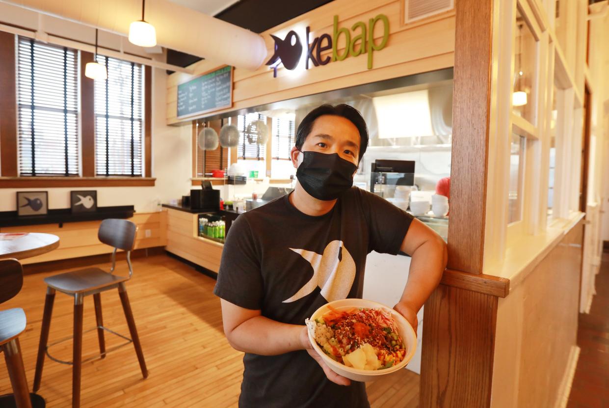 Pokebap owner Seas Kim with his signature dish, pokebap. It includes cucumber, edamame, mango, carrot, sweet onions, kani, scallions, tuna, salmon, pickeled ginger, crispy garlic and kani. He is one of the ten initial restaurants in the Budd Dairy Food Hall, which is part of the Cameron Mitchell Restaurants portfolio.