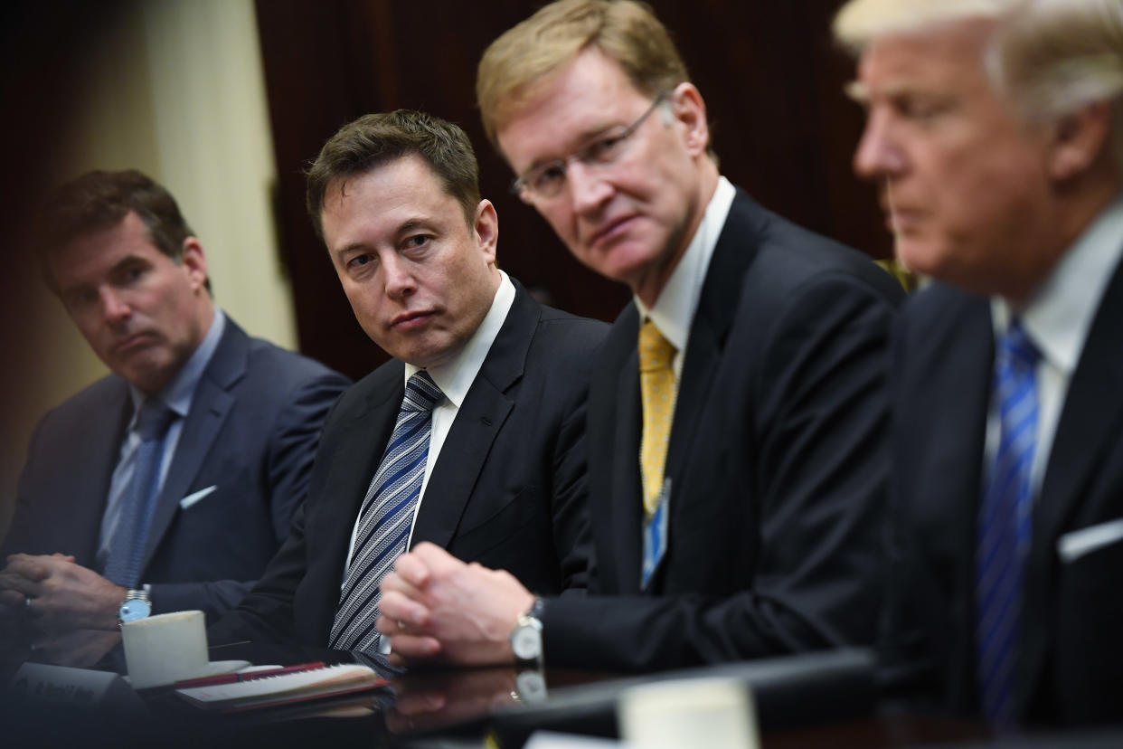 WASHINGTON, DC - JANUARY 23: Kevin Plank of Under Armour, left to center, Elon Musk of SpaceX and Wendell P. Weeks of Corning listen to President Donald Trump during a meeting with business leaders in the Roosevelt Room of the White House on Monday January 23, 2017 in Washington, DC. CEO's from a number of top U.S. companies were in attendance. The president spoke about possible cuts in regulations that can be made. (Photo by Matt McClain/The Washington Post via Getty Images)